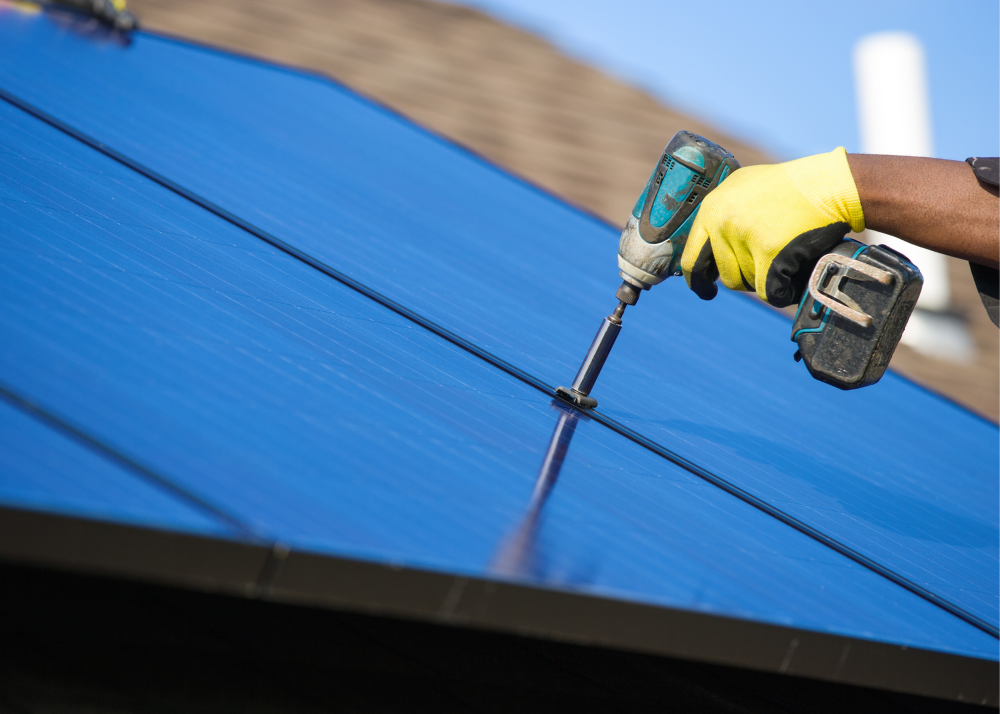 Solar panels being installed on a commercial roofing system